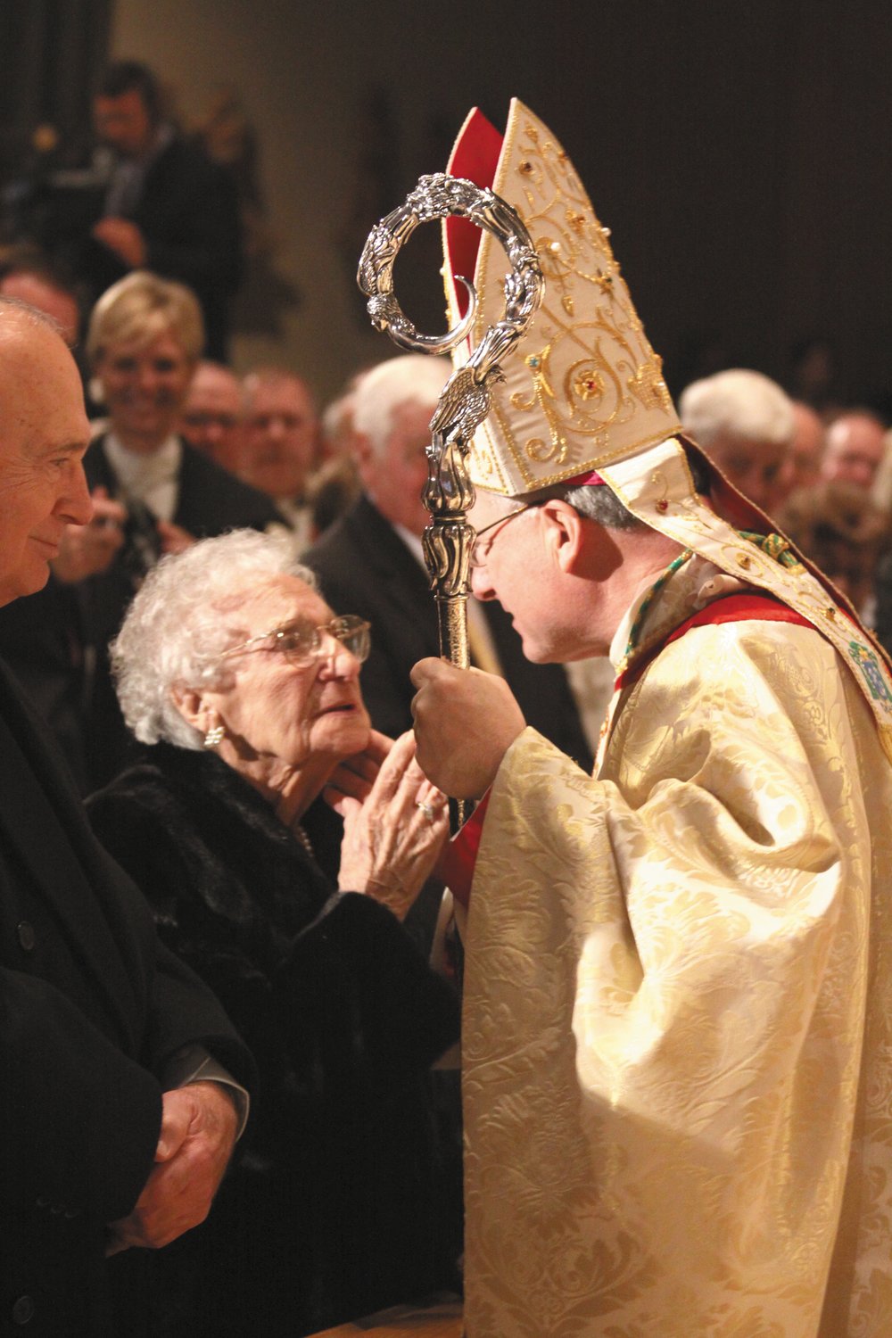 Bishop Evans receives a kiss from his dear mother at his episcopal ordination on December 15, 2009, in the Cathedral of Saints Peter and Paul, Providence.